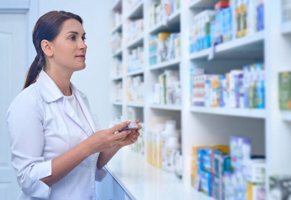 At work. Female pharmacist working in a drugstore